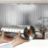 Hands hold a cylindrical metal object with a mirror effect finish against a vertical ribbed wall.