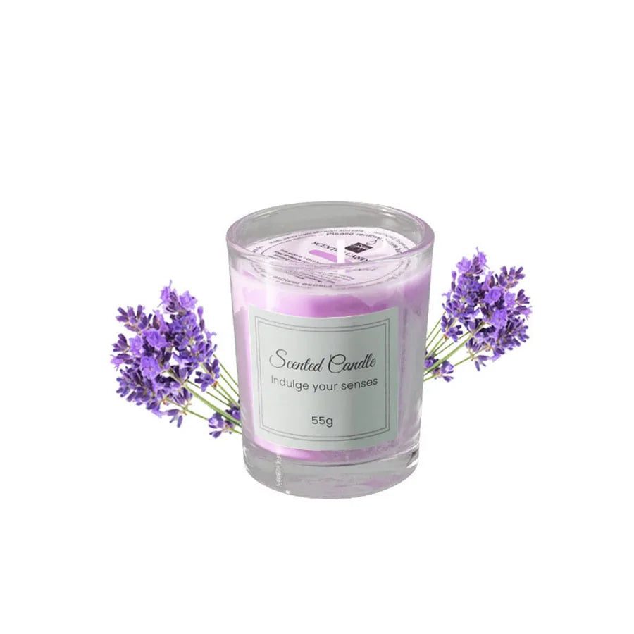 A jar of lavender scented candle with a pink hue and purple dried flowers surrounding it.