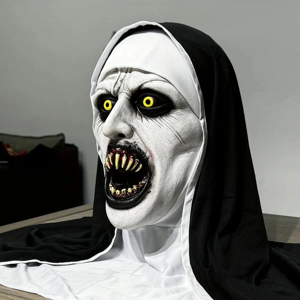 A realistic horror nun latex mask with pale white skin, black veil, and exaggerated facial features.