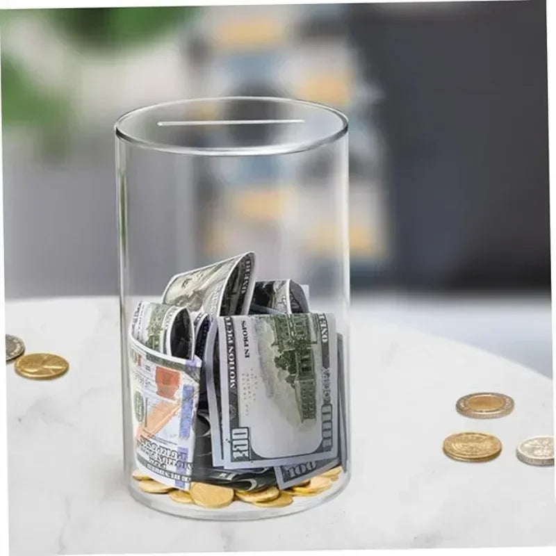 A clear glass jar filled with various US dollar bills and coins on a white surface.