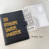 A black binder for a 100 envelope savings challenge with numbered pockets and a saving tracker sheet.