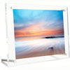 A clear acrylic photo frame displaying a vibrant sunset sky over the ocean.