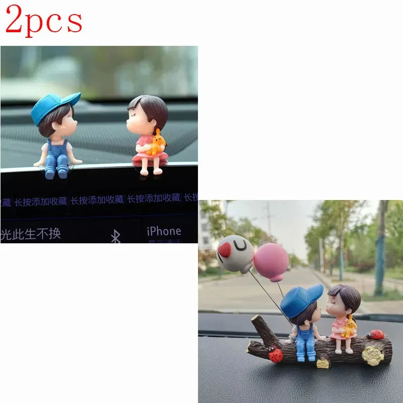 A set of two cute couple balloon car ornaments featuring a boy and a girl.