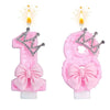 A set of pink bow crown number birthday candles, featuring the number 1 and 8.