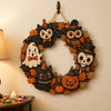 Vintage wooden Halloween wreath featuring carved cats, an owl, and a skull surrounded by autumn leaves