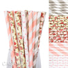 A collection of colorful striped and polka dot paper drinking straws in various pink, cream, and gray shades.