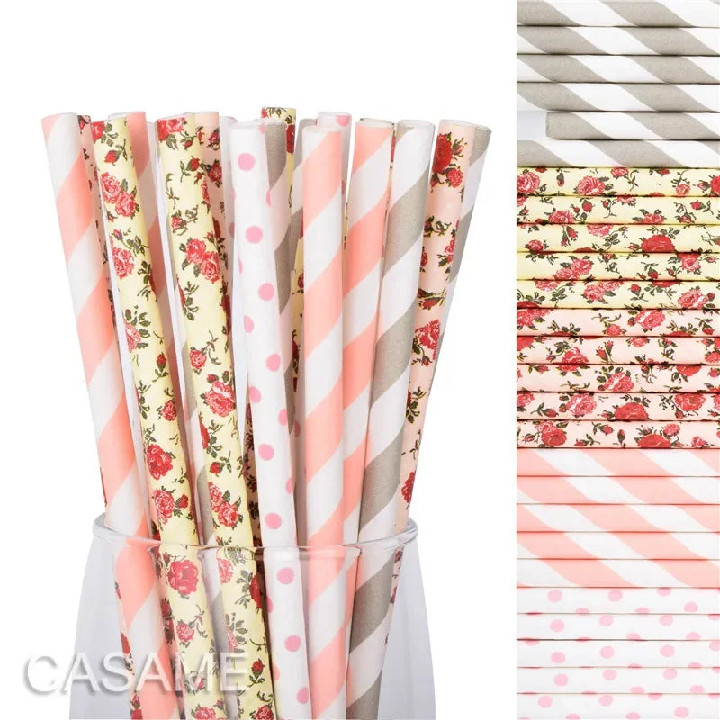 A collection of colorful striped and polka dot paper drinking straws in various pink, cream, and gray shades.