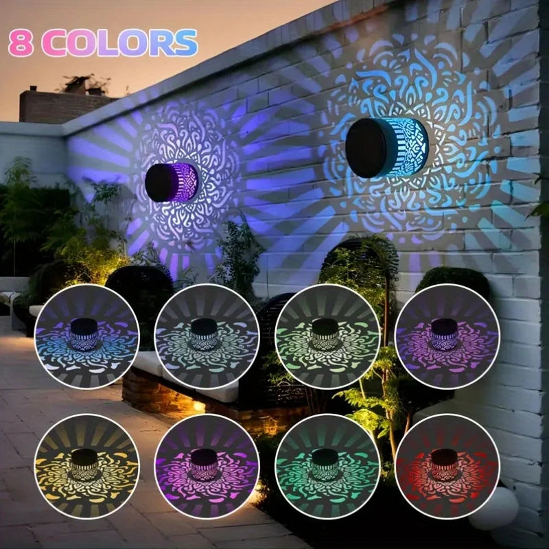 Eight colored solar-powered mandala wall lanterns illuminating a stone wall in a garden setting.