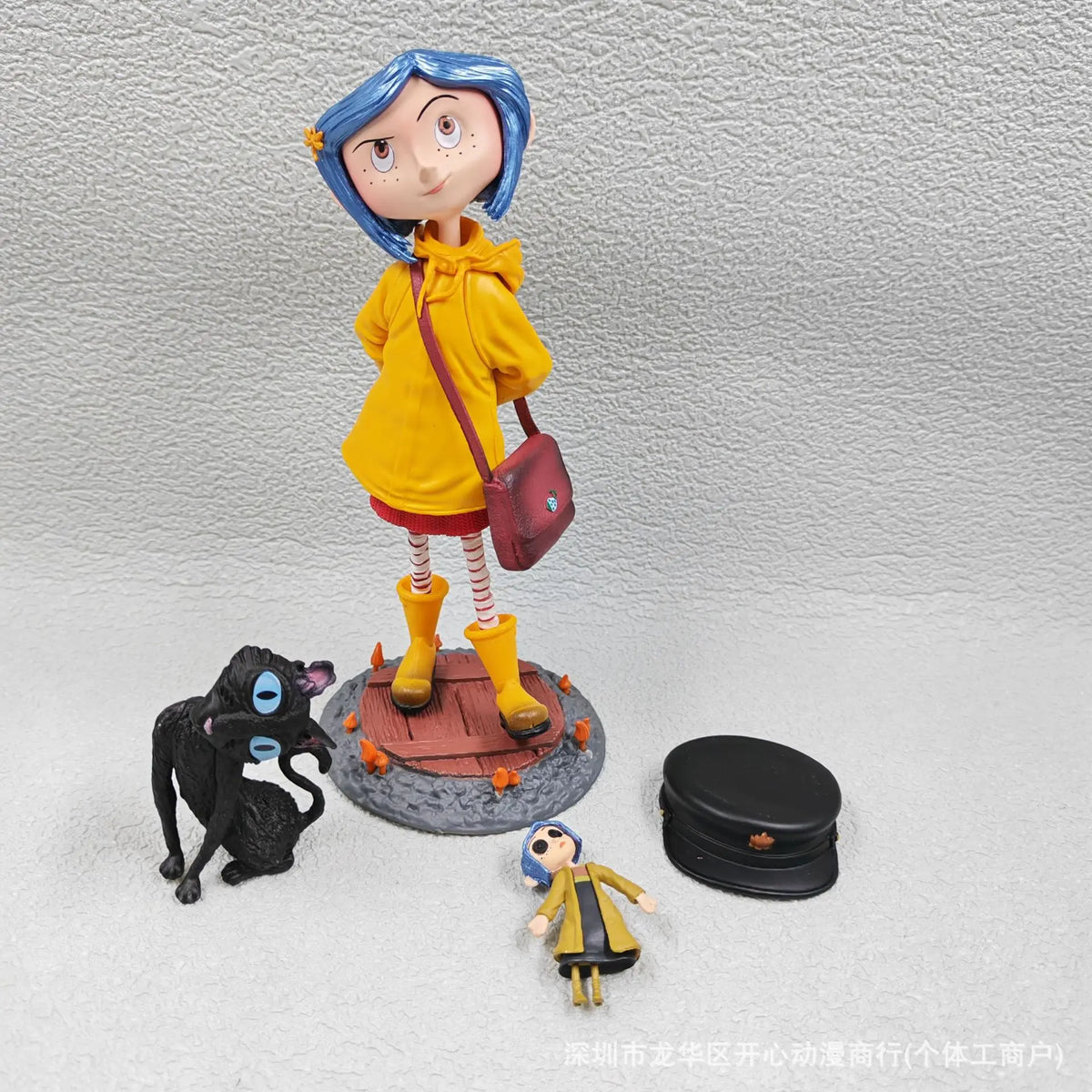 A yellow-clad doll figurine resembling Caroline Black Cat standing on a circular base.