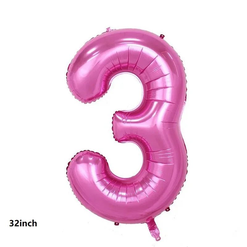 A large pink foil balloon shaped like the number three