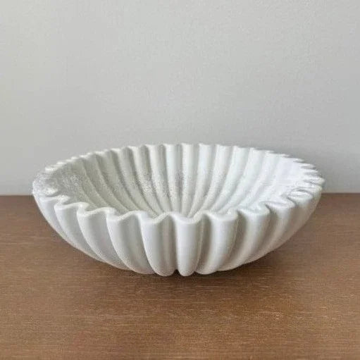 White lotus leaf resin decorative bowl with ribbed texture on a wooden surface