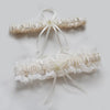 Ivory lace bowknot bridal garter set featuring delicate white lace and sheer ribbons