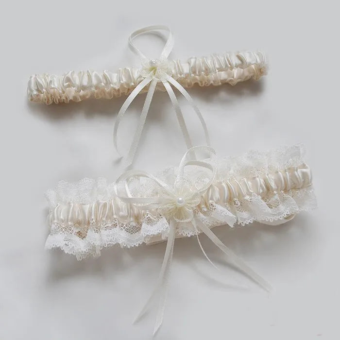 Ivory lace bowknot bridal garter set featuring delicate white lace and sheer ribbons