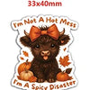 A brown, fluffy animal charm resembling a baby goat or lamb with an orange bow, labeled as I'm a spicy disaster.