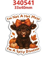 A brown, fluffy animal charm resembling a baby goat or lamb with an orange bow, labeled as I'm a spicy disaster.