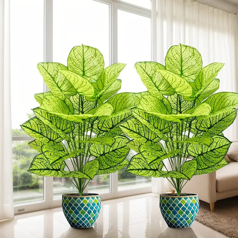 A set of two realistic artificial floor plants with large green leaves in potted containers near a window.