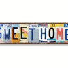 Vintage retro metal street sign with the words SWEETHOME in distressed lettering.