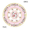A set of 10 vintage floral paper party tableware including plates, cups, and napkins in pink and white.
