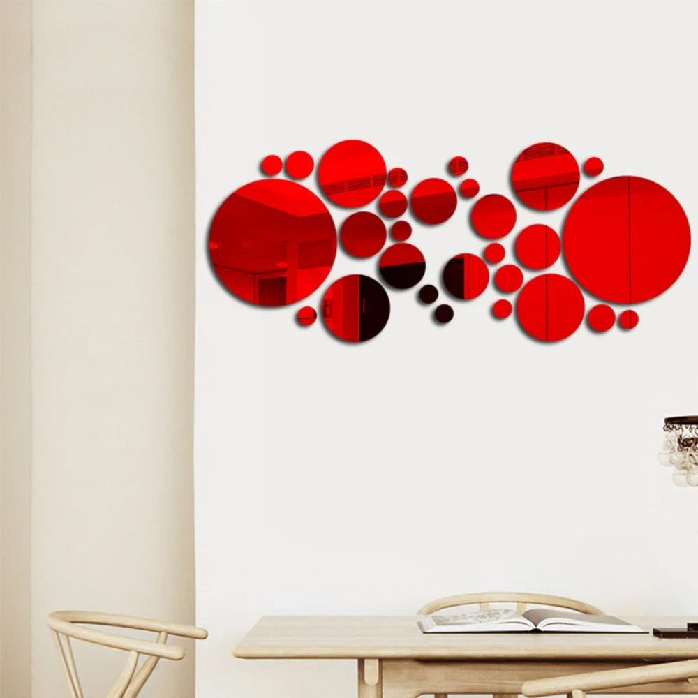 Abstract red circular mirror decals arranged in a scattered pattern on a white wall.