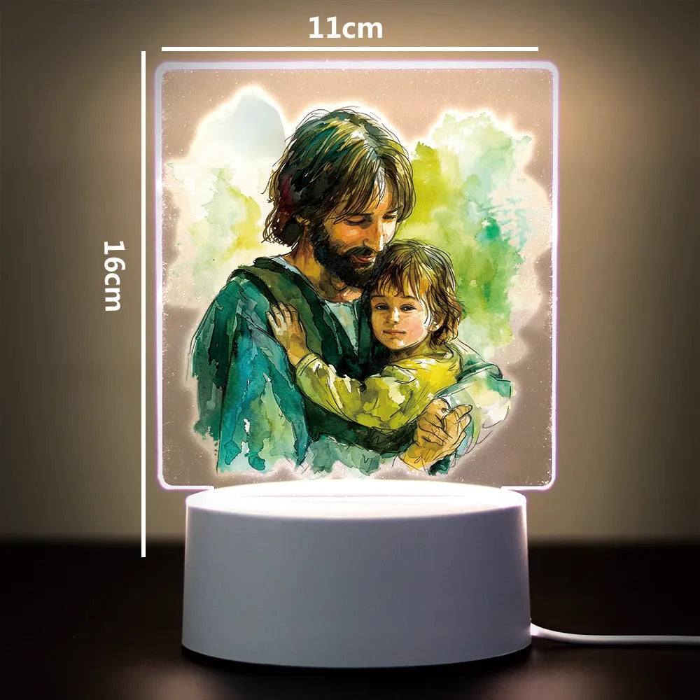 A 3D LED night light illuminates a painting of a man holding a child in green and yellow tones.