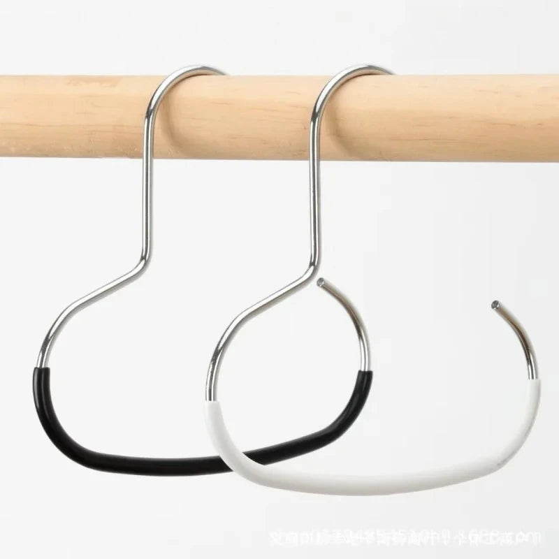 A silver round hook for hats, ties, scarves, and bags is hanging from a wooden rod.
