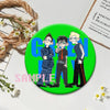 A set of collectible button pins featuring three stylized characters from a punk band album cover on a bright green backgroun