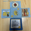 Handcrafted pocket shrine featuring a cross and religious imagery on blue fabric
