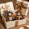 A small brown cow figurine wearing a hat and sitting next to a cup of coffee inside a gift box.