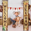 A young boy dressed in western attire sits with a lamb in front of a wooden banner decorated with the words WELCOME YEAH HAW