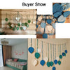 Bohemian macrame leaf wall hanging with blue and green tassels displayed on a wooden background.