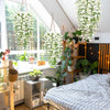 Artificial morning glory hanging vine with white flowers displayed in a bright room setting