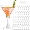 A collection of 18 disposable clear plastic martini glasses with stems arranged in rows.
