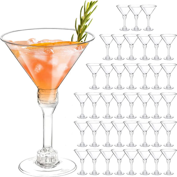 A collection of 18 disposable clear plastic martini glasses with stems arranged in rows.