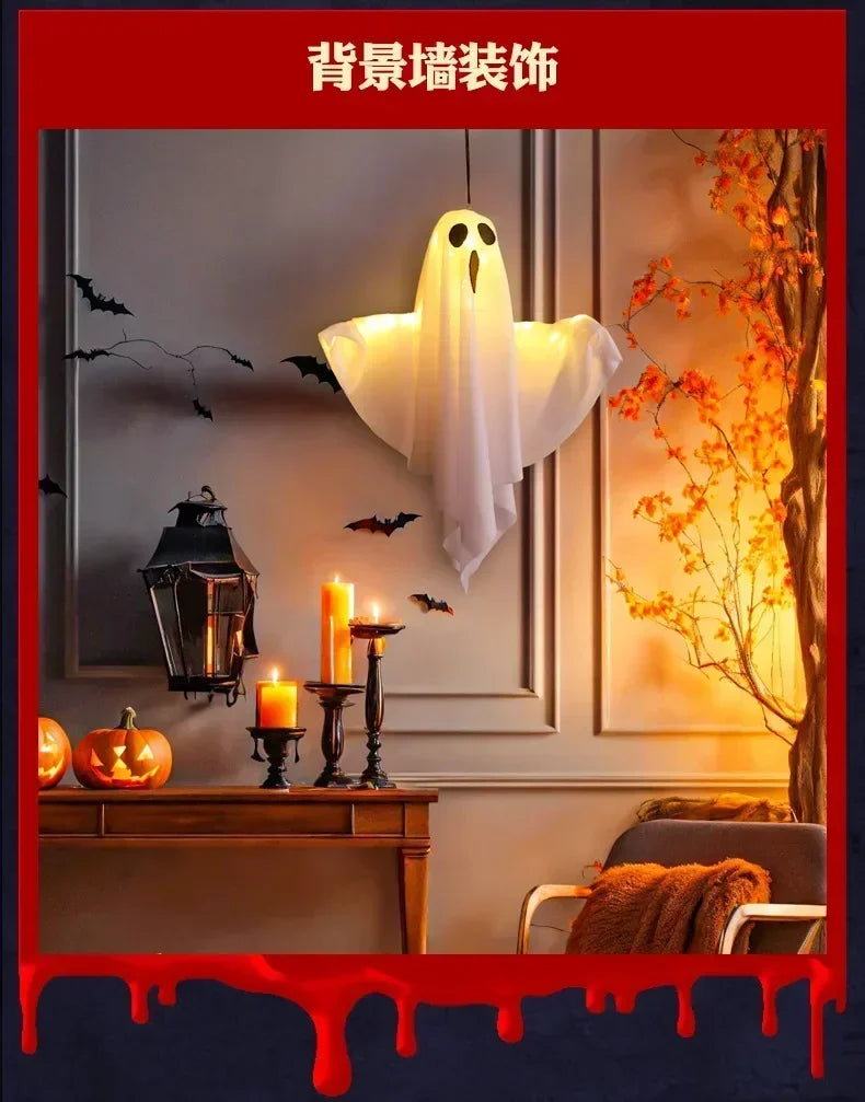 A white ghost light decoration is hanging on a wall in a dimly lit room with autumn foliage visible.