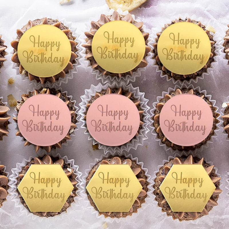 A set of ten edible cupcake toppers in gold and pink colors with various birthday messages