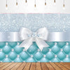 A light blue and silver glitter backdrop featuring a white bow tie design for a birthday party.