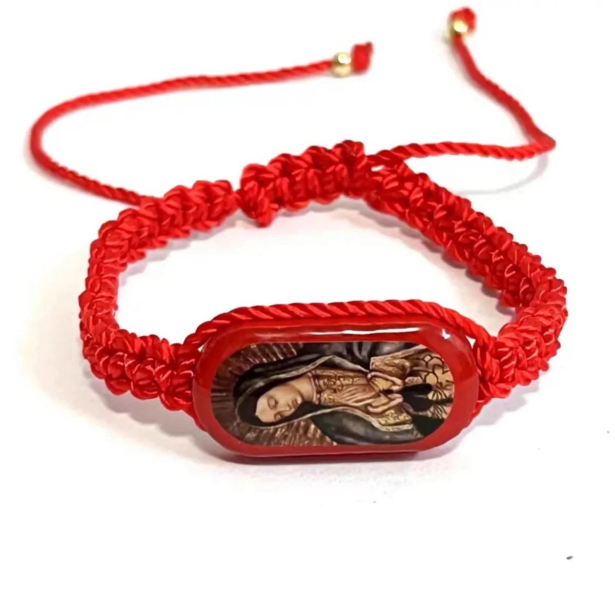 A vintage wooden prayer bracelet made of red cord featuring an engraved image of the Virgin Mary.