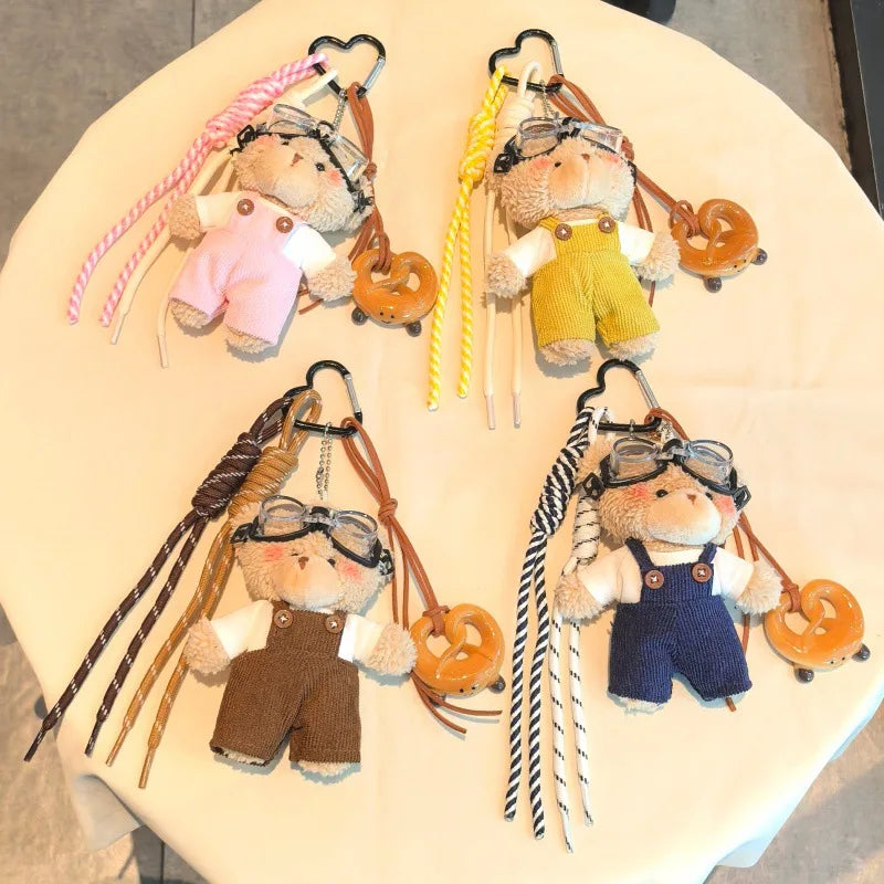Collection de porte-clés ours en peluche à thème aviateur, dans diverses couleurs et styles.