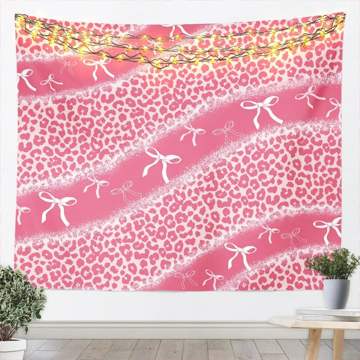 Pink leopard print tapestry wall hanging featuring white glitter accents and bow details.