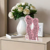 A bouquet of white roses in a vase next to a personalized acrylic plaque for Mother's Day gifts