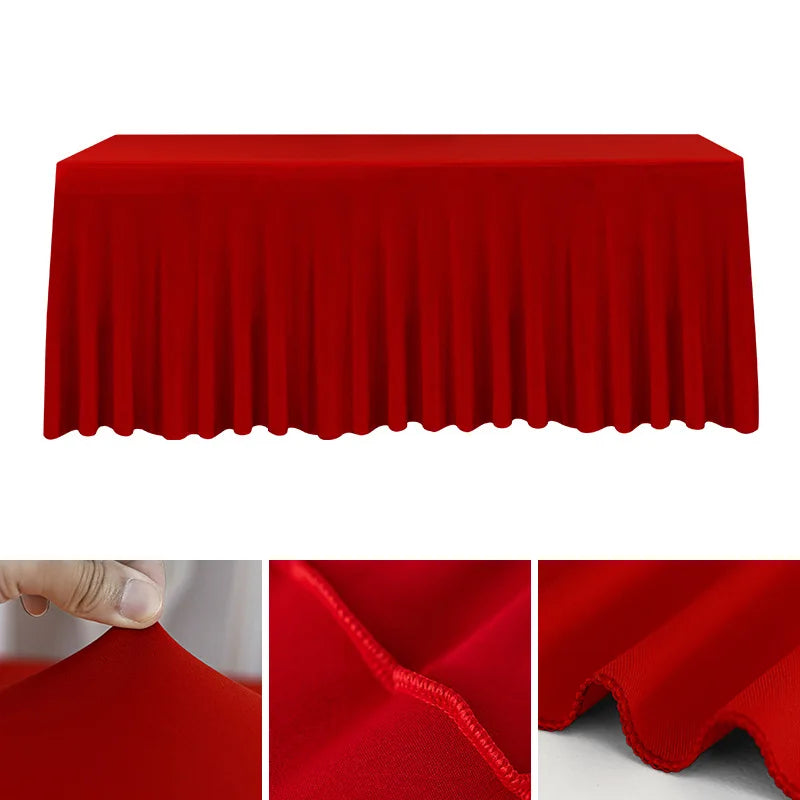 A vibrant red stretch rectangle tablecloth draped over a table, showing its texture and folds.