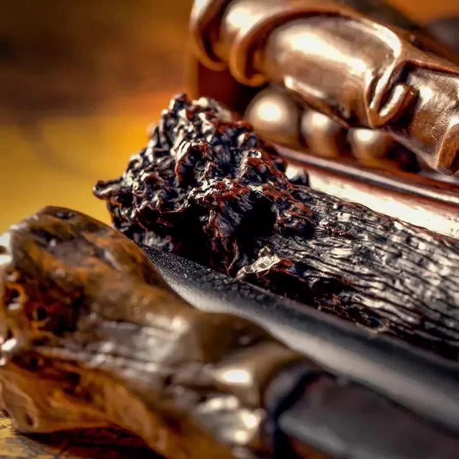 A close-up of a collection of character-inspired metal and resin magic wands resting on a dark surface.
