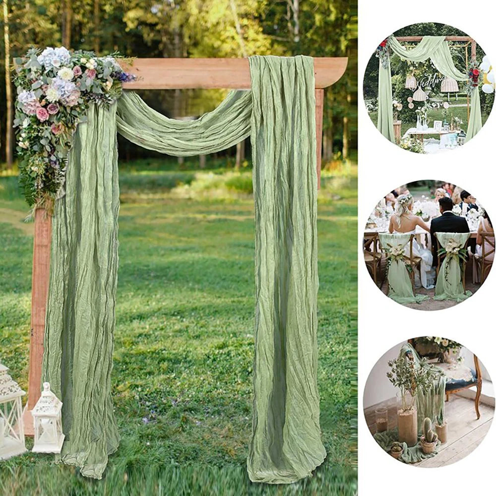 Sage green gauze fabric draped as a wedding arbor backdrop with floral greenery