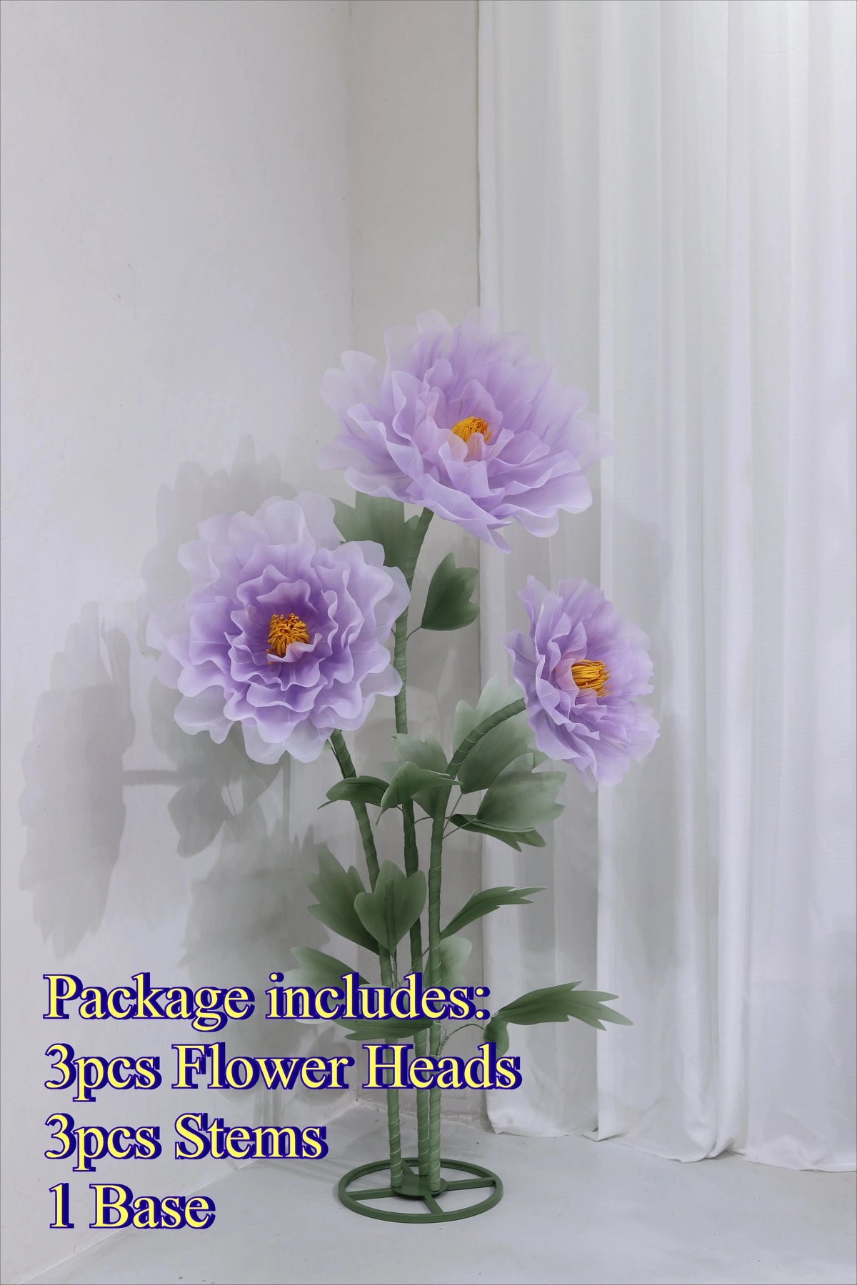A bouquet of three purple silk poppy flower heads on green stems displayed in a circular base.