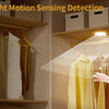 Day/Night motion sensing detection light illuminating clothing on a hanger.