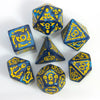 A set of seven polyhedral dice in blue and yellow colors arranged on a white surface.