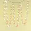 A strand of crystal glass octagon beads suspended by a silver chain, used for home decor.