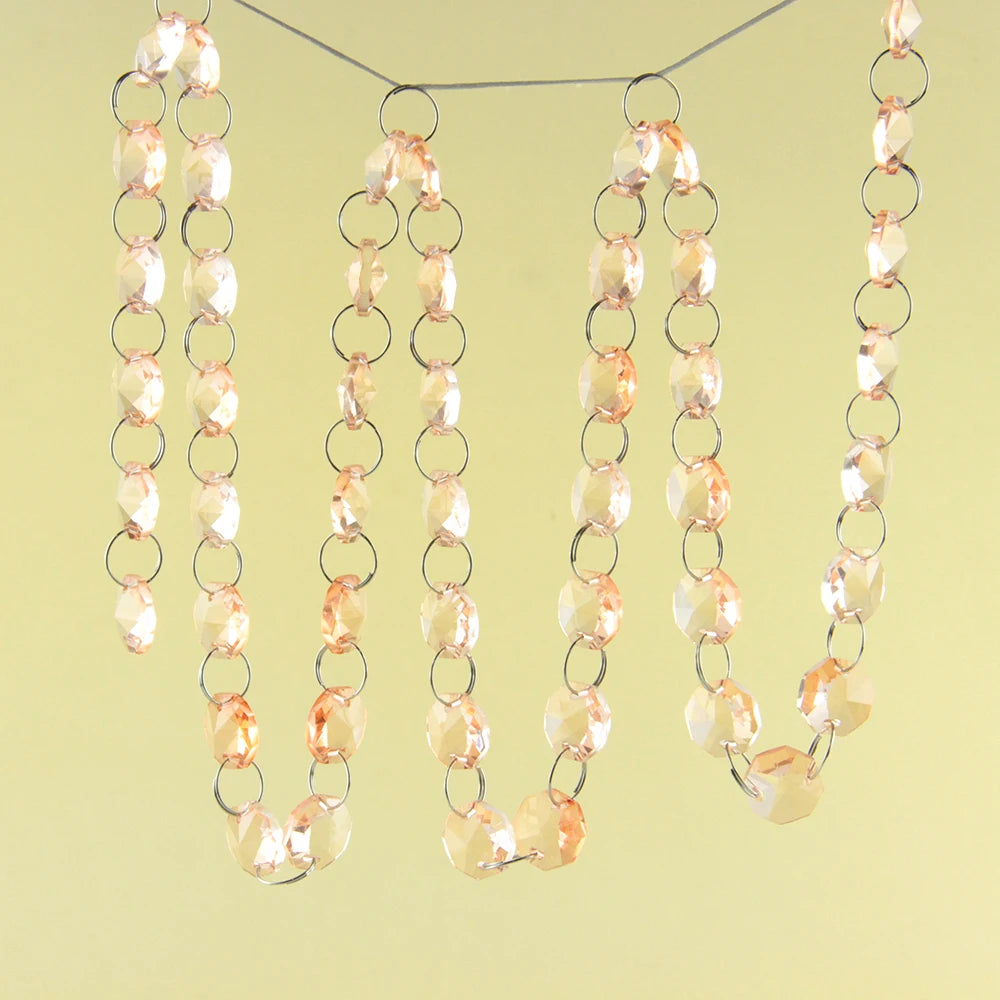 A strand of crystal glass octagon beads suspended by a silver chain, used for home decor.