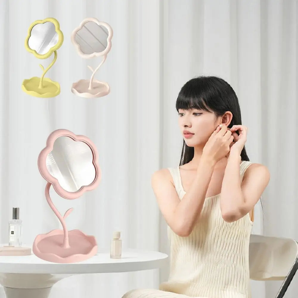 A pink sunflower heart dressing makeup mirror is displayed next to a woman applying makeup.