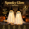 Dos figuras fantasma blancas con sombreros de bruja brillan sobre una superficie para decoración de Halloween